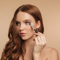 beauty-portrait-mystery-smiling-ginger-woman-with-long-hair-looking-away-while-applying-cosmetics-with-brush-eyeshadow beauty-portrait-mystery-smiling-ginger-woman-with-long-hair-looking-away-while-applying-cosmetics-with-brush-eyeshadow