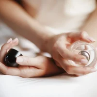 bride-holds-bottle-parfume-her-tender-arms bride-holds-bottle-parfume-her-tender-arms