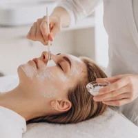 cosmetologist-doing-face-treatment-applying-face-mask cosmetologist-doing-face-treatment-applying-face-mask